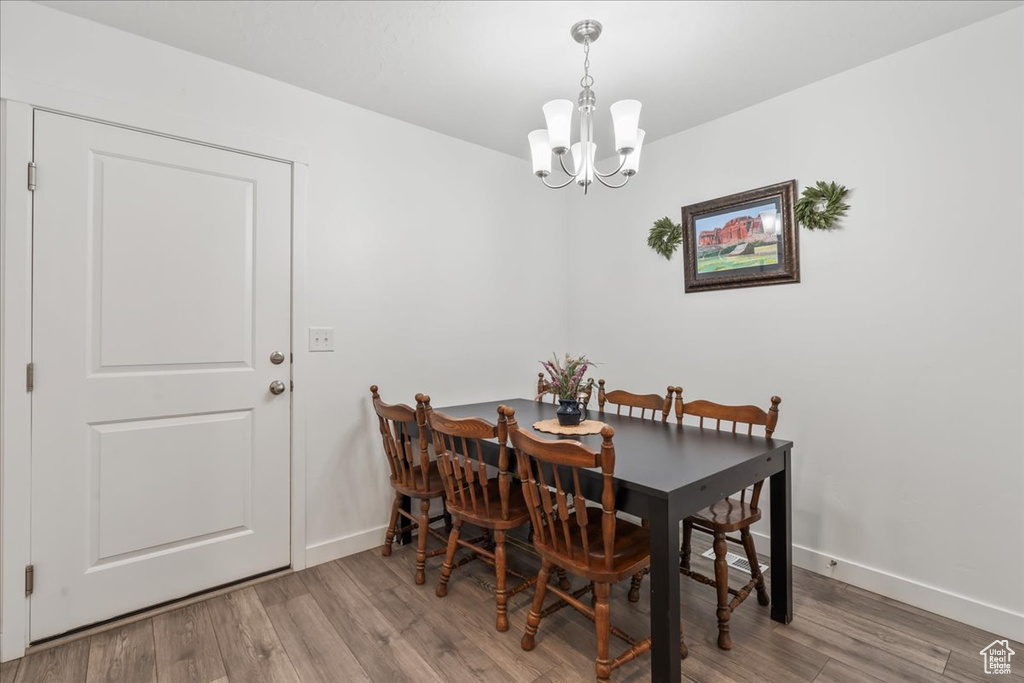Dining room featuring a chandelier and wood finished floors