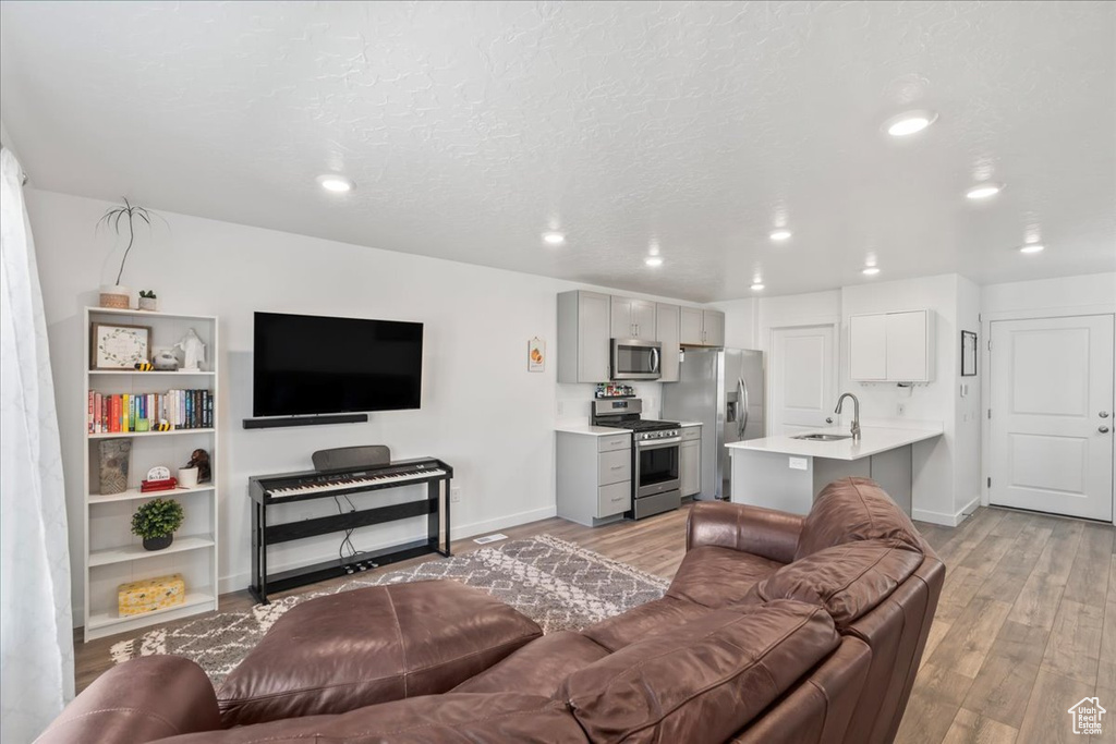 Living room featuring light wood-style floors and recessed lighting