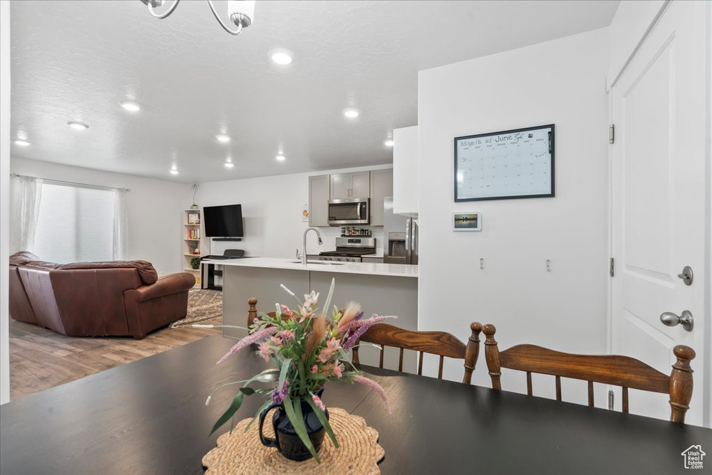 Dining room featuring light wood finished floors and recessed lighting