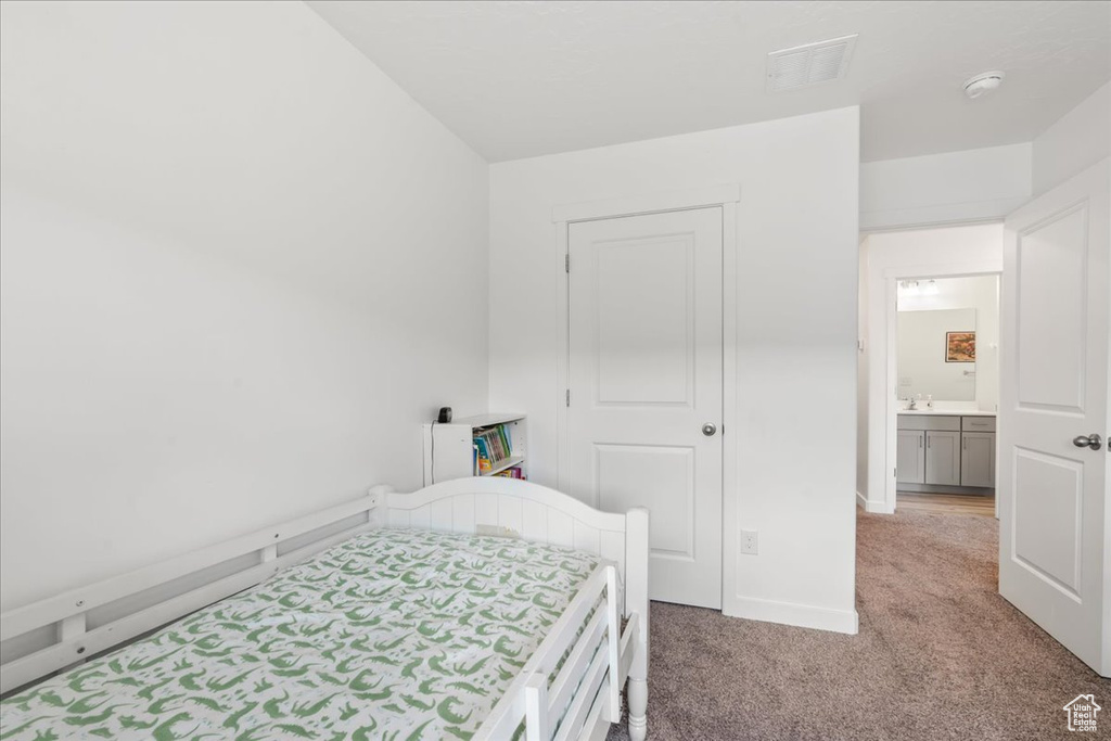 Bedroom with light carpet