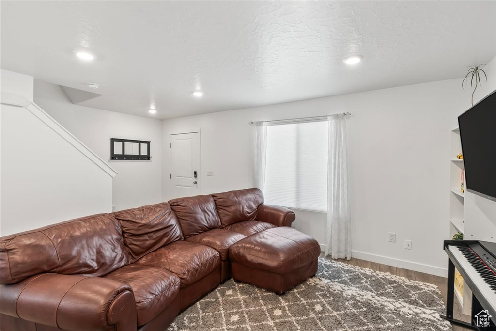 Living room featuring wood finished floors and recessed lighting