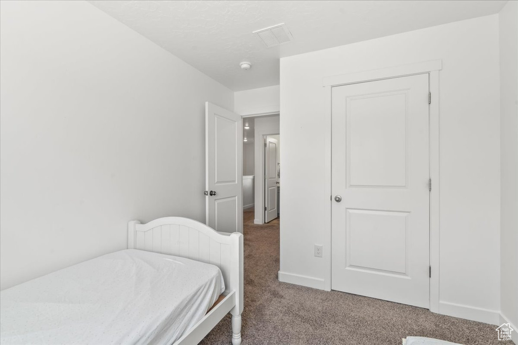 Carpeted bedroom featuring baseboards