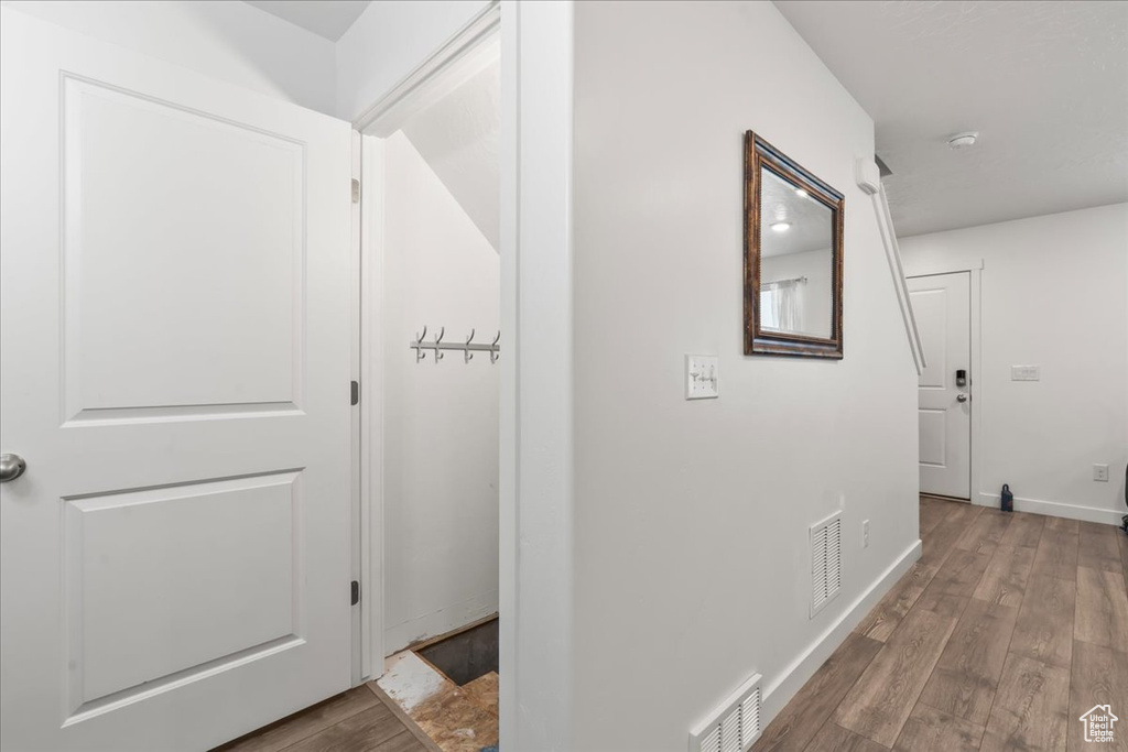 Hall featuring wood finished floors and baseboards
