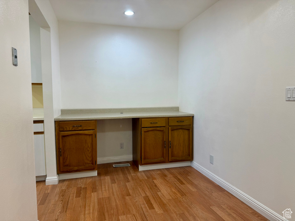Unfurnished office featuring light wood-style floors and recessed lighting