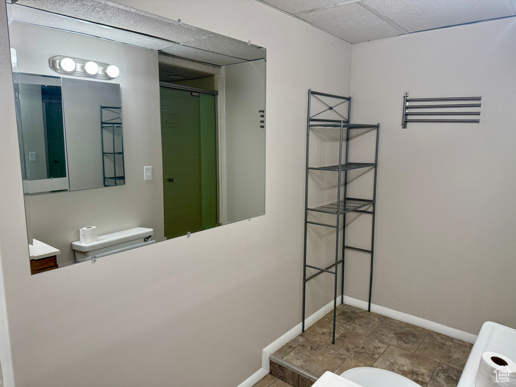 Bathroom featuring baseboards and toilet