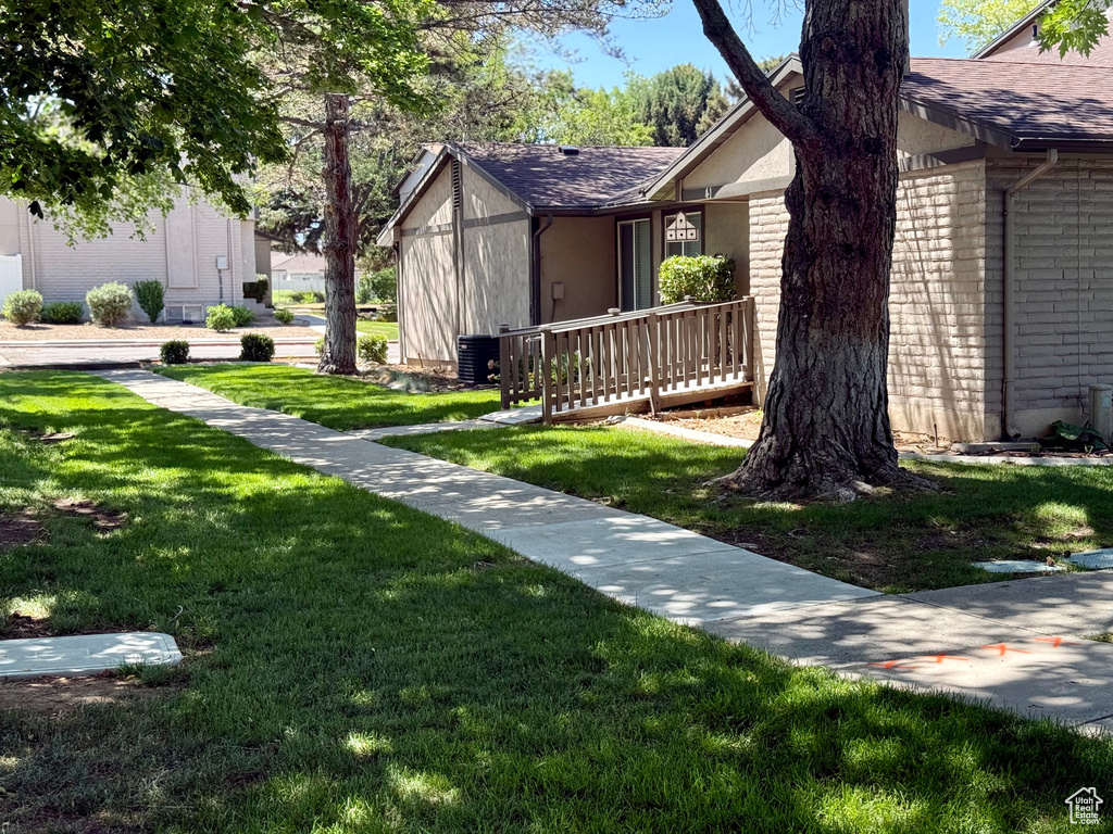 View of front of property with a front yard and roof with shingles