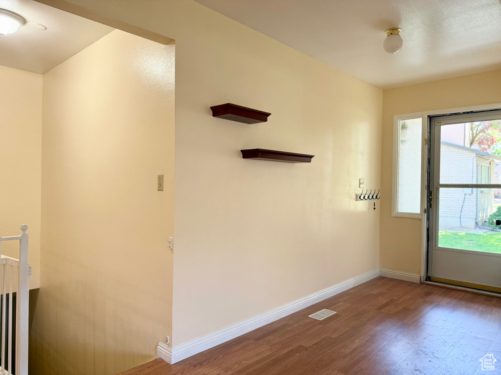 Spare room featuring wood finished floors and baseboards