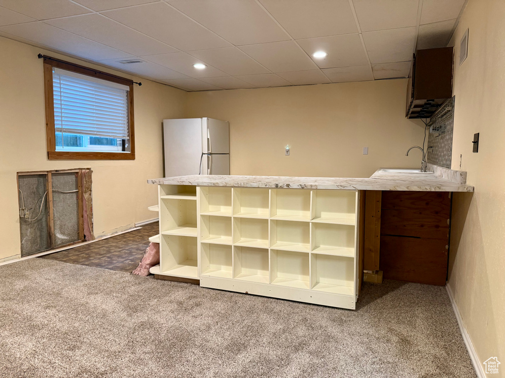 Kitchen featuring freestanding refrigerator, open shelves, carpet flooring, a paneled ceiling, and recessed lighting