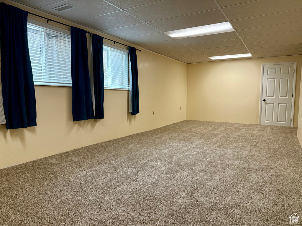 Carpeted empty room with a paneled ceiling