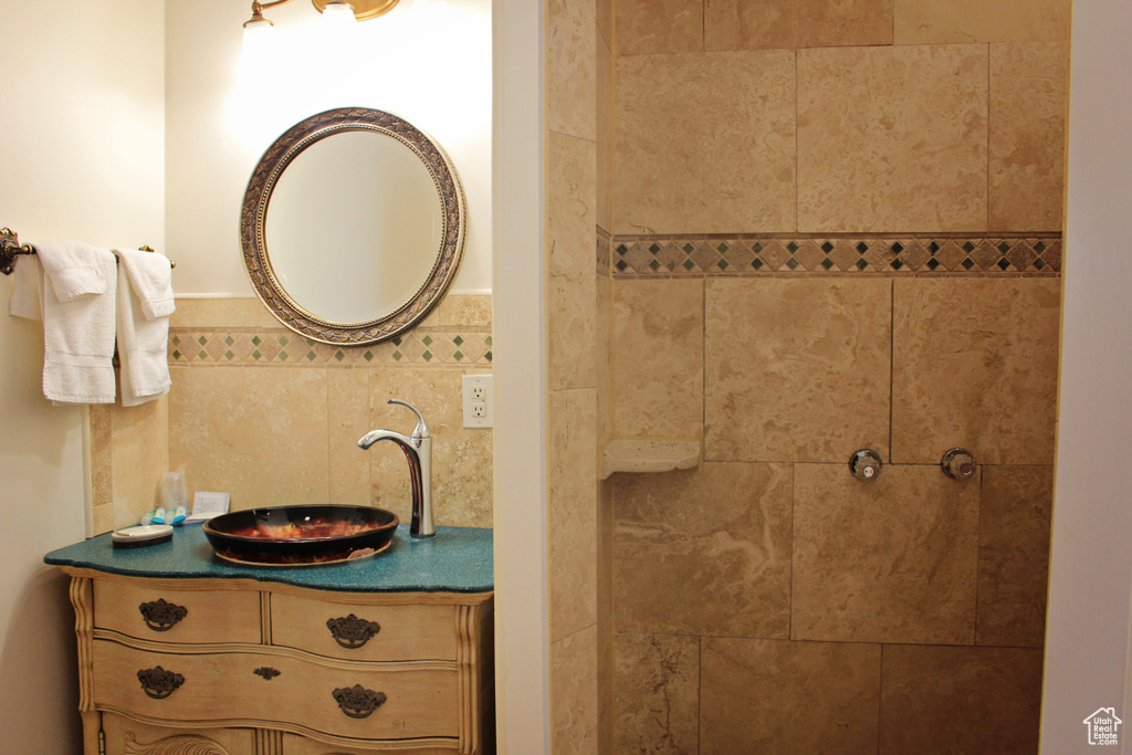 Full bathroom with vanity and tiled shower