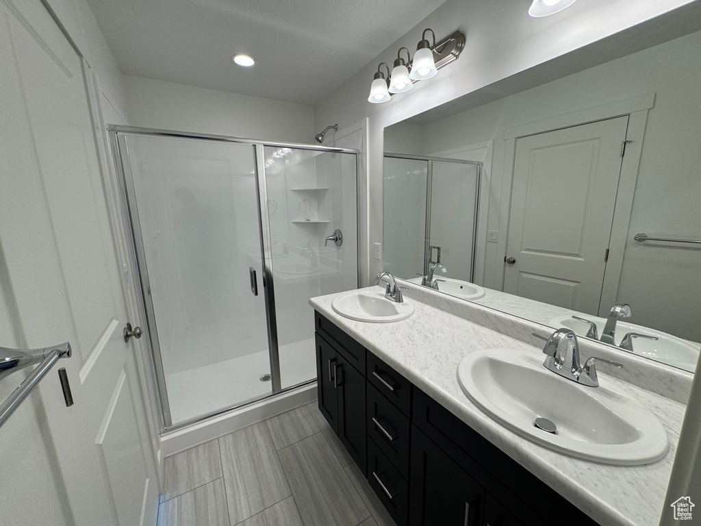 Full bathroom with a stall shower and double vanity