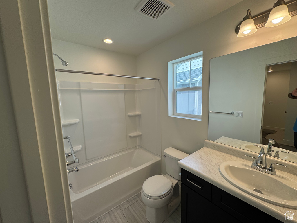 Full bath featuring  shower combination, vanity, and recessed lighting