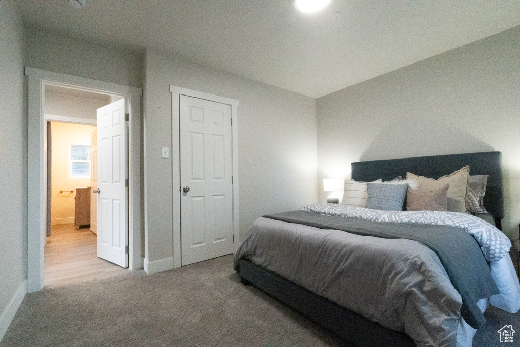 Bedroom featuring carpet and baseboards