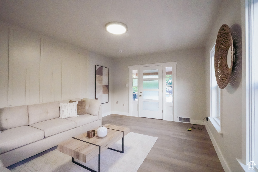 Living area with light wood-style flooring and baseboards