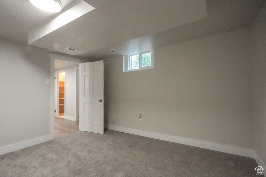 Basement featuring carpet and baseboards
