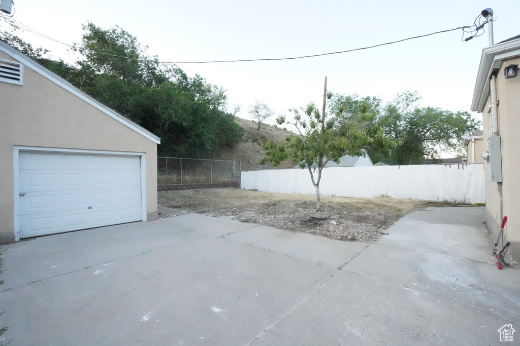 Garage featuring concrete driveway