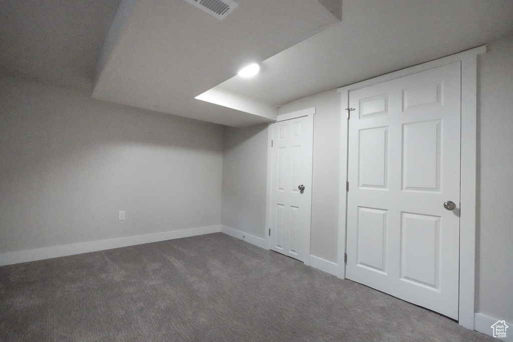 Finished below grade area featuring carpet flooring and baseboards