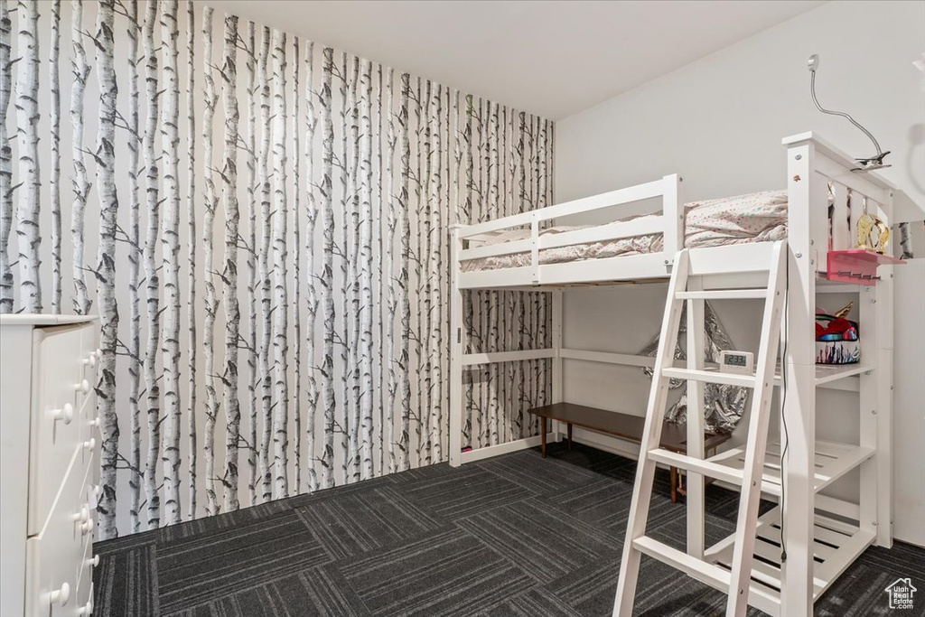 Unfurnished bedroom featuring carpet floors and an accent wall