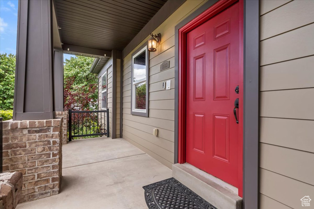 Doorway to property with covered porch