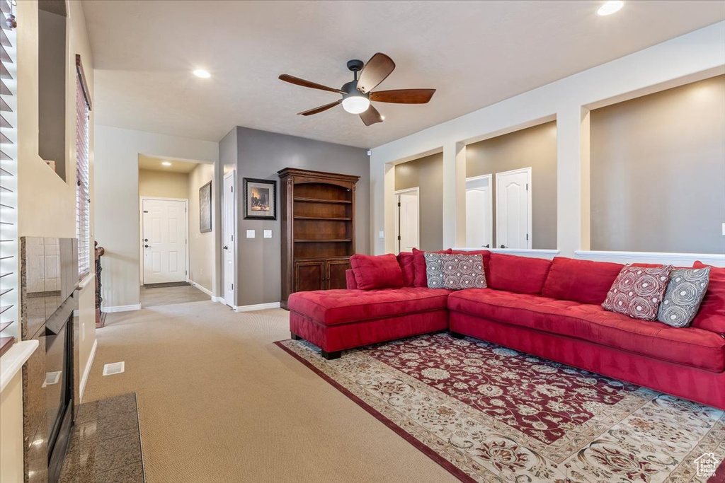 Living room featuring ceiling fan, carpet, and recessed lighting