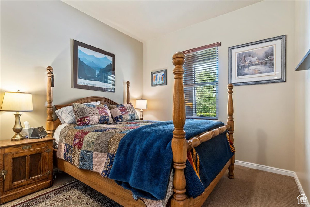Carpeted bedroom featuring baseboards
