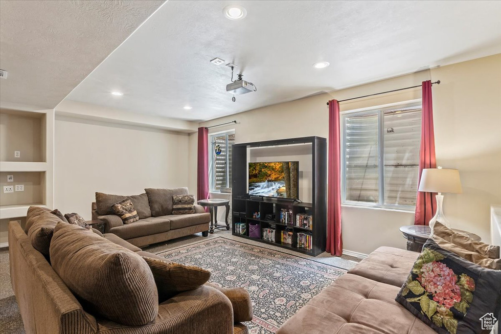 Carpeted living room featuring recessed lighting