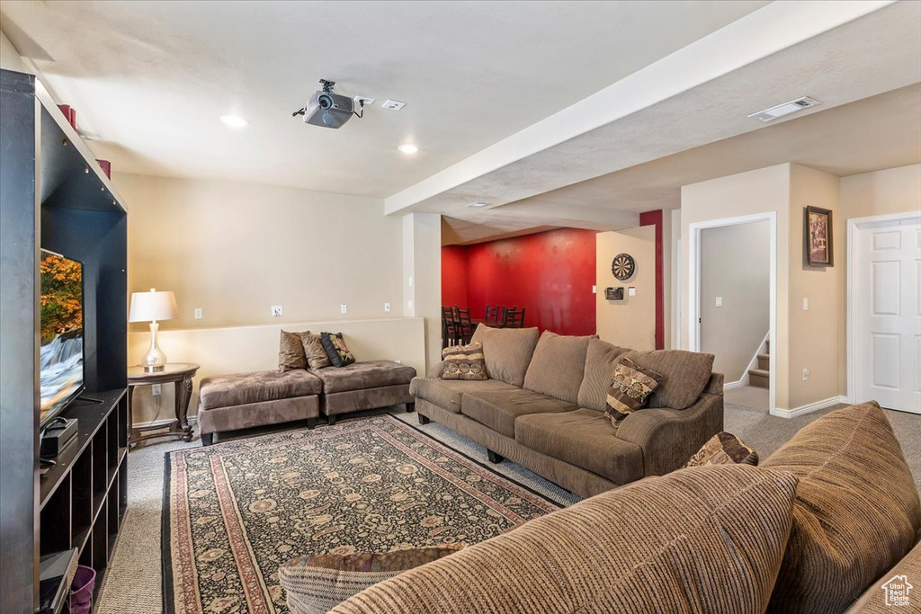 Living room with carpet flooring, stairway, and recessed lighting
