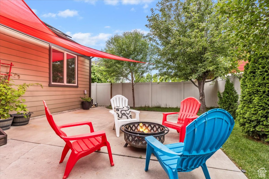 View of patio with a fire pit