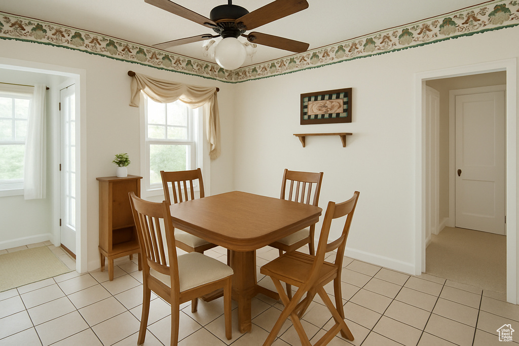 Dining room with ceiling fan and light tile patterned floors