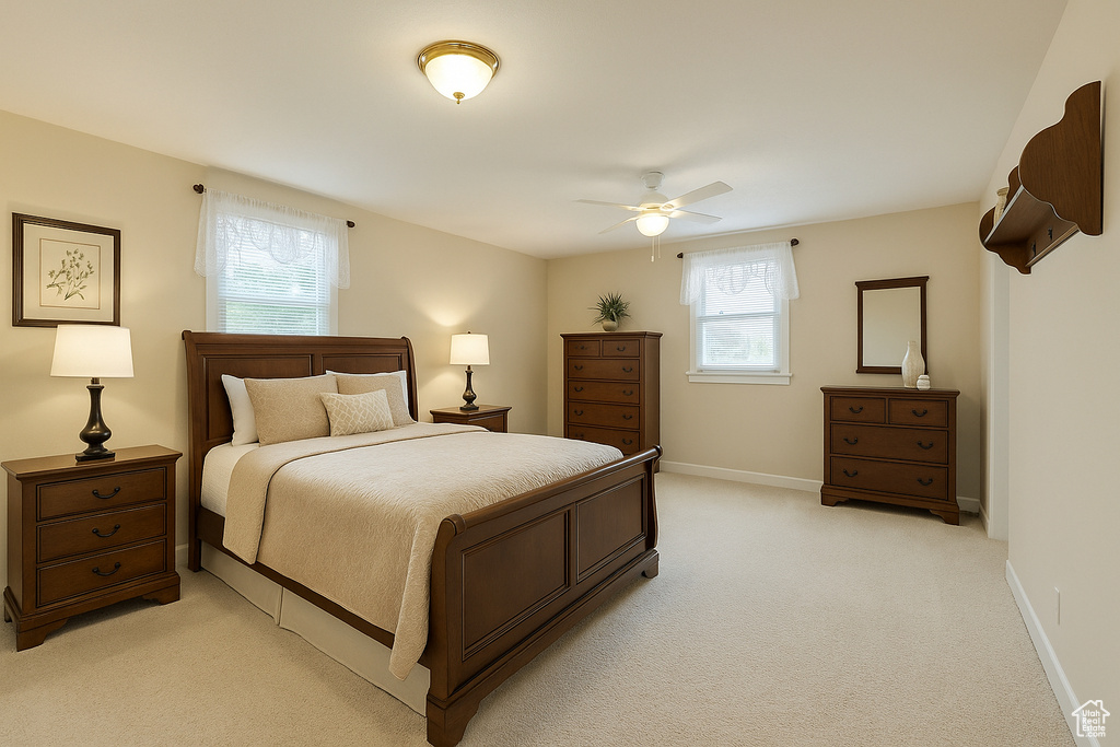 Bedroom featuring light colored carpet and a ceiling fan