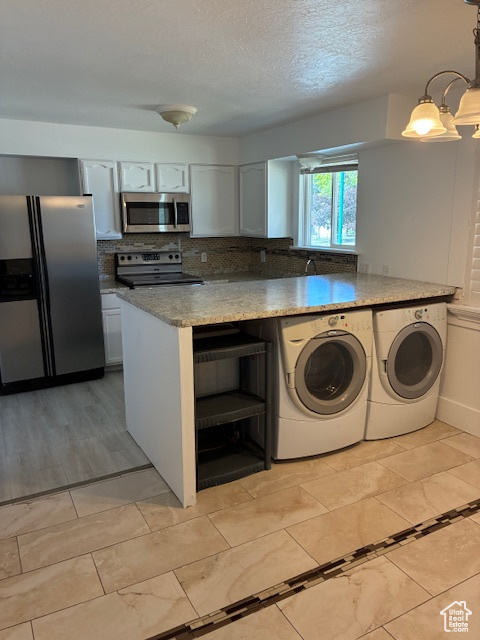 Kitchen with stainless steel appliances, washing machine and dryer, backsplash, open shelves, and light stone counters