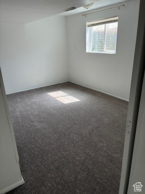 Carpeted spare room with baseboards