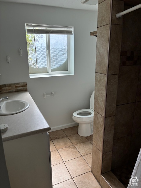 Bathroom with vanity, a shower stall, and tile patterned flooring