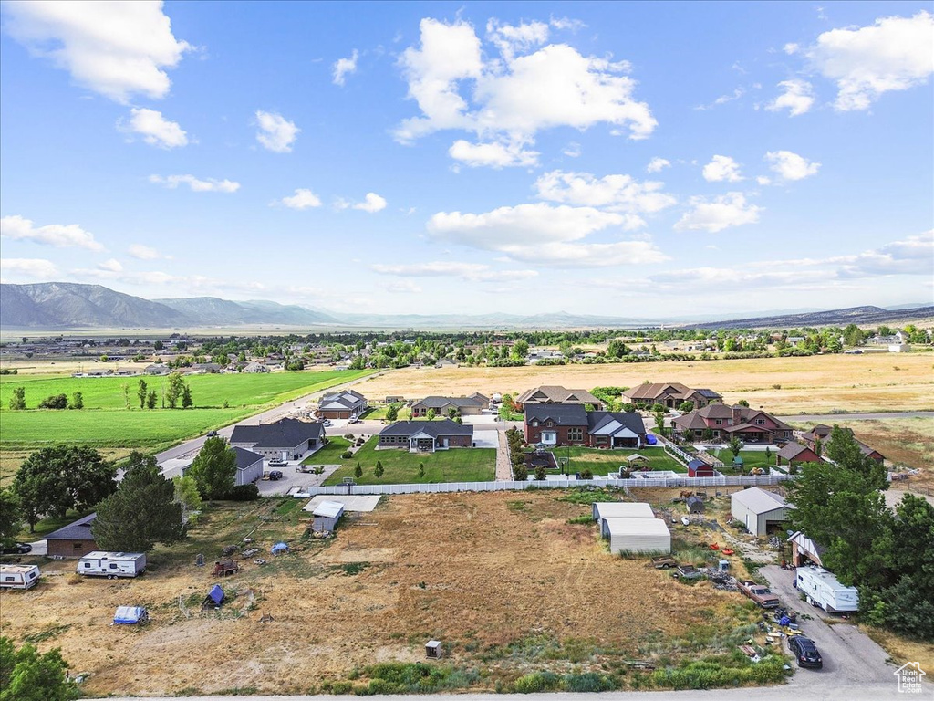 Aerial view of sparsely populated area with a mountain backdrop and nearby suburban area