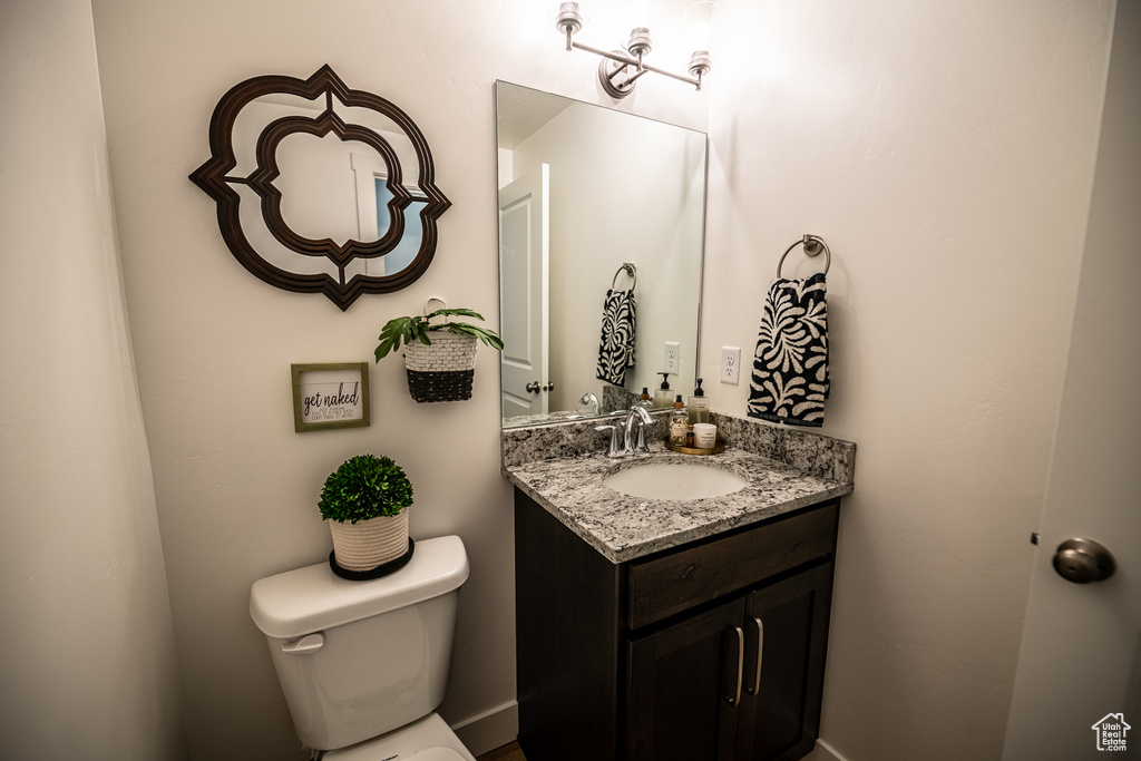 Half bathroom with toilet and vanity