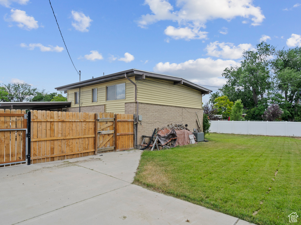 View of property exterior featuring a gate