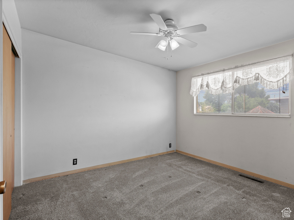 Unfurnished bedroom with carpet floors, a closet, and ceiling fan