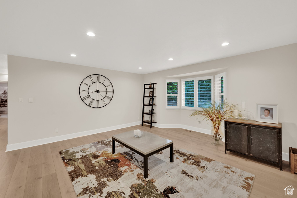 Living area with wood finished floors and recessed lighting