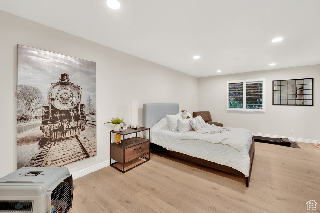 Bedroom featuring recessed lighting, light wood-type flooring, and heating unit