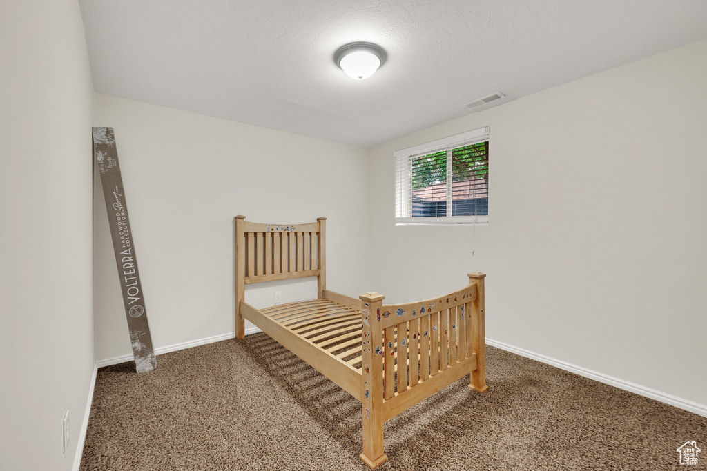 Bedroom featuring carpet flooring and baseboards
