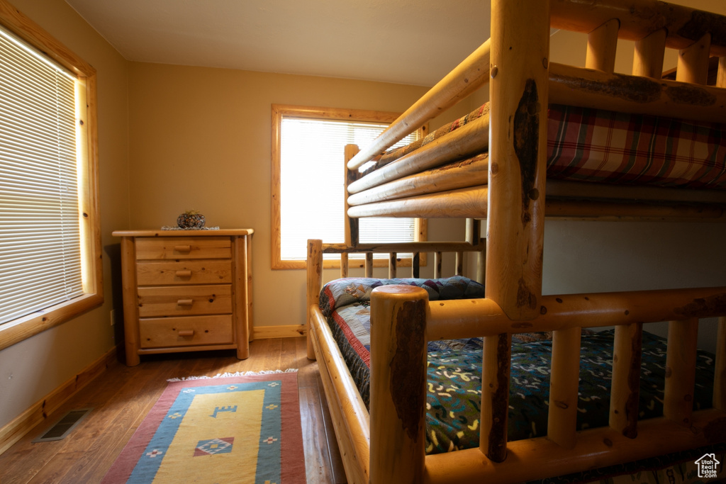 Bedroom featuring baseboards and wood finished floors