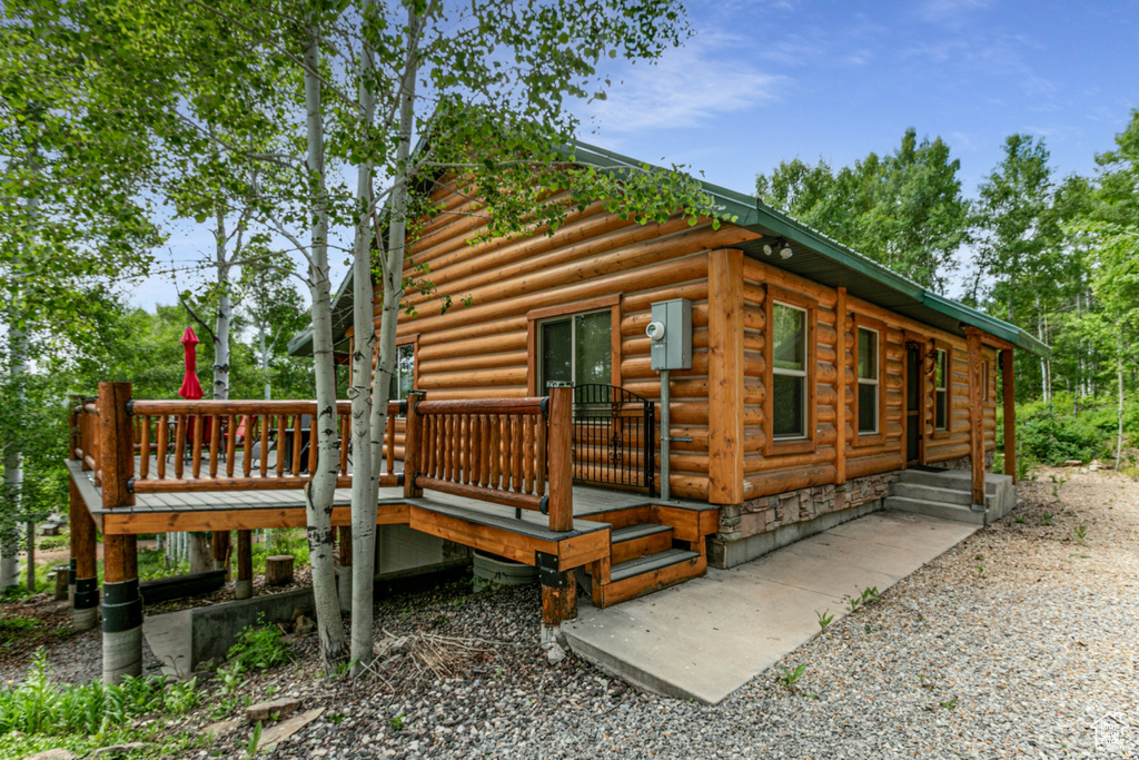 View of side of home featuring a deck