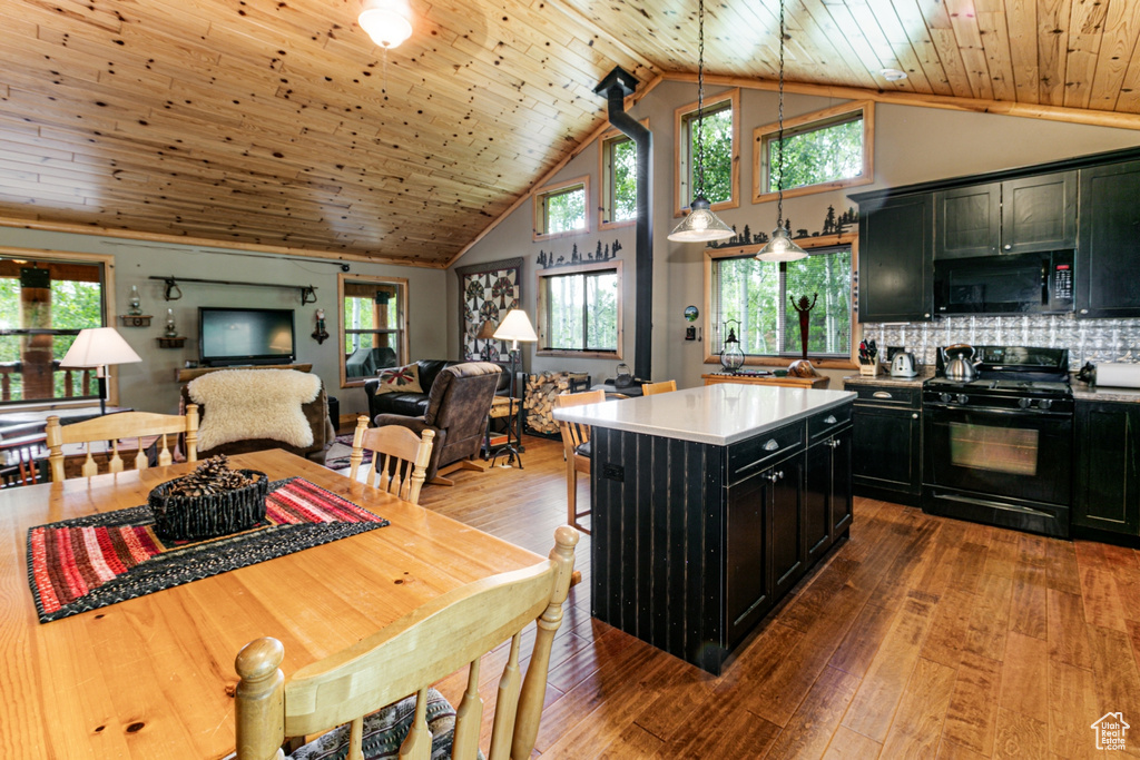 Kitchen with black appliances, dark cabinetry, open floor plan, wood ceiling, and wood-type flooring