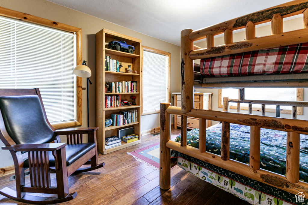 Bedroom featuring hardwood / wood-style flooring and baseboards