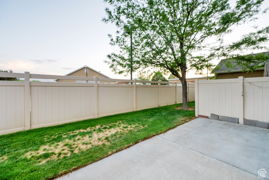 Fenced backyard with a patio