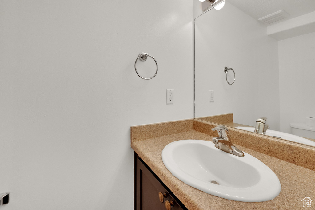 Bathroom featuring vanity and toilet