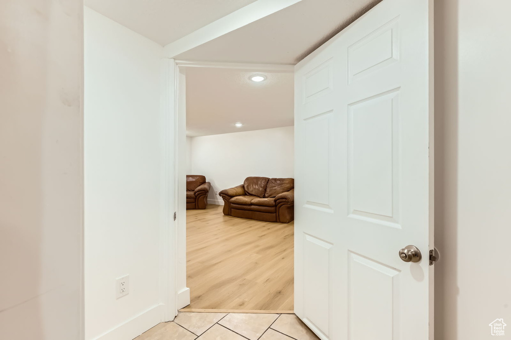 Hall featuring light tile patterned floors and recessed lighting