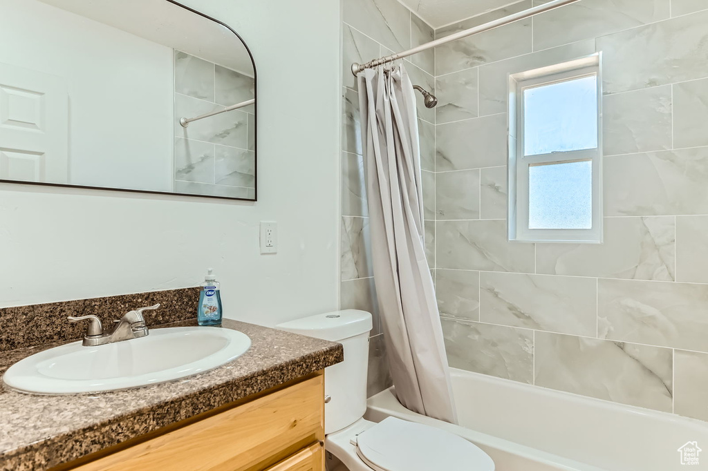 Bathroom featuring vanity and shower / tub combo