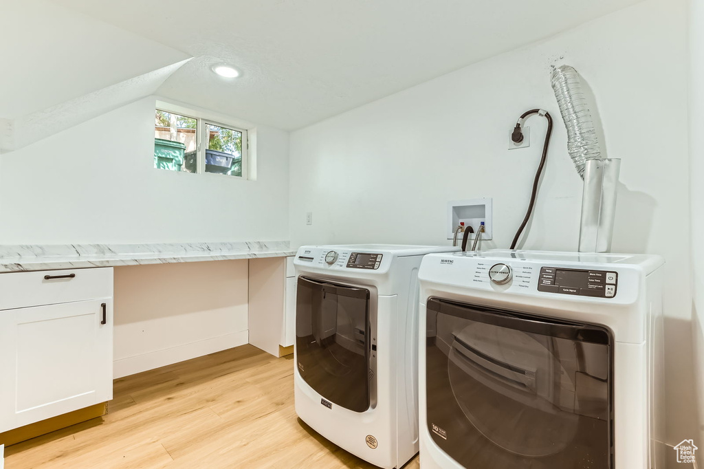 Laundry room featuring cabinet space, light wood-style flooring, washing machine and clothes dryer, recessed lighting, and a desk