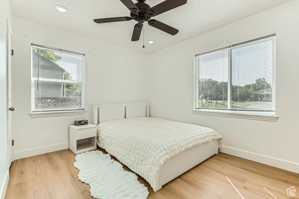 Bedroom with light wood-style flooring, recessed lighting, and a ceiling fan